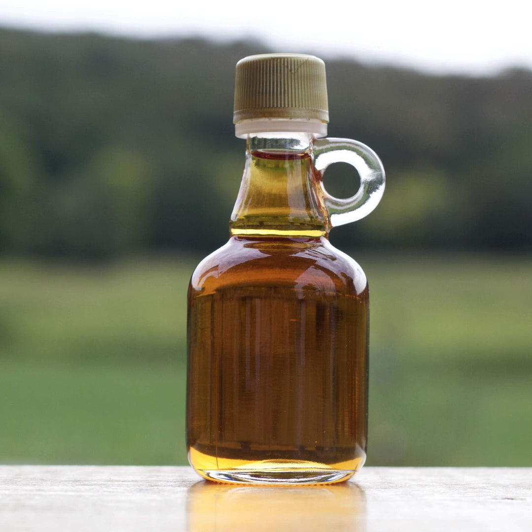 A rustic wedding favor in a farm setting, these bottles of maple syrup with a handle work perfectly.